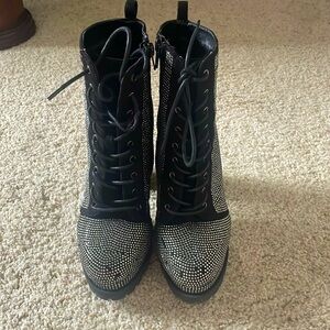 Black and silver heeled boots missing a few gems